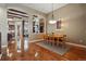 Open concept dining room with hardwood floors and an arched entryway to the kitchen at 7831 Inverness Blvd, Englewood, CO 80112