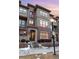 Charming brick and stucco townhome with a private entrance and well-maintained landscaping at 7831 Inverness Blvd, Englewood, CO 80112