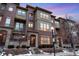 Charming three-story townhouse with brick and stucco exterior at 7831 Inverness Blvd, Englewood, CO 80112