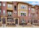 Charming three-story townhouse with a brick facade, lovely windows, and an inviting entrance at 7831 Inverness Blvd, Englewood, CO 80112