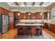 Spacious kitchen with wood cabinets, granite countertops, stainless steel appliances, and a large island at 7831 Inverness Blvd, Englewood, CO 80112