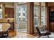 Inviting living room boasts hardwood floors, balcony access, and abundant natural light at 7831 Inverness Blvd, Englewood, CO 80112