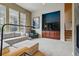 Cozy living room featuring large windows and a staircase, perfect for entertaining at 7831 Inverness Blvd, Englewood, CO 80112