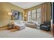 Inviting living room is complete with neutral carpeting and streaming natural light at 7831 Inverness Blvd, Englewood, CO 80112