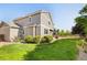 Well-maintained back yard with lush lawn, mature landscaping, and a patio for outdoor seating at 10978 Ashurst Ln, Highlands Ranch, CO 80130