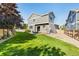Spacious backyard with a patio area, manicured lawn, and privacy fence at 10978 Ashurst Ln, Highlands Ranch, CO 80130