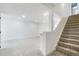 Finished basement with carpeted floors, recessed lighting, and access to carpeted stairs at 10978 Ashurst Ln, Highlands Ranch, CO 80130