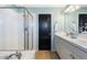 Bathroom featuring double sinks, a shower with glass doors, and an adjacent bathtub at 10978 Ashurst Ln, Highlands Ranch, CO 80130