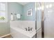 Bathroom featuring a bathtub, shower with glass doors, and shuttered windows at 10978 Ashurst Ln, Highlands Ranch, CO 80130