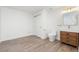 Bathroom featuring wood look floors, a wood vanity, and a toilet at 10978 Ashurst Ln, Highlands Ranch, CO 80130