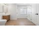 Bathroom featuring tile floors, a wood vanity, framed mirror, and glass shower at 10978 Ashurst Ln, Highlands Ranch, CO 80130