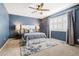 Stylish bedroom featuring a ceiling fan, rug, two side lamps, and shuttered windows at 10978 Ashurst Ln, Highlands Ranch, CO 80130