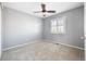 Neutral bedroom with plush carpet, ceiling fan, and bright natural light through white shuttered window at 10978 Ashurst Ln, Highlands Ranch, CO 80130