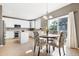 Bright kitchen with white cabinetry, stainless steel appliances, and a breakfast nook with backyard views at 10978 Ashurst Ln, Highlands Ranch, CO 80130
