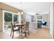 Breakfast nook with sliding doors leading to a backyard, open to living room with brick fireplace at 10978 Ashurst Ln, Highlands Ranch, CO 80130