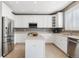 Spacious kitchen featuring white cabinets, stainless steel appliances, and a functional center island at 10978 Ashurst Ln, Highlands Ranch, CO 80130