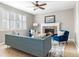 Cozy living room with a brick fireplace, ample seating, and natural light through shuttered windows at 10978 Ashurst Ln, Highlands Ranch, CO 80130