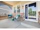 Inviting front porch with cozy seating, brick accents, and a stylish front door, perfect for relaxing at 10978 Ashurst Ln, Highlands Ranch, CO 80130