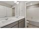 Clean bathroom with double vanity, a large mirror and tub shower at 14249 Beebalm Ave, Parker, CO 80134