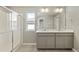 Well-lit bathroom features double sinks and a glass door shower, ideal for a growing Gathering at 14249 Beebalm Ave, Parker, CO 80134