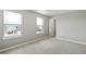 Bright bedroom featuring a neutral color scheme, soft carpeting and large windows at 14249 Beebalm Ave, Parker, CO 80134