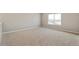 Spacious room with neutral carpet and large window overlooking the backyard at 14249 Beebalm Ave, Parker, CO 80134