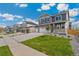 Beautiful two-story home exhibiting a three-car garage, green lawn, and well-maintained surroundings at 14249 Beebalm Ave, Parker, CO 80134