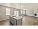Open concept kitchen flows into living area with fireplace and lots of natural light at 14249 Beebalm Ave, Parker, CO 80134