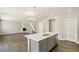 Open concept kitchen flows into living area with fireplace and lots of natural light at 14249 Beebalm Ave, Parker, CO 80134