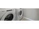 Close up of a new, front loading Whirlpool washer and dryer in the laundry room at 14249 Beebalm Ave, Parker, CO 80134