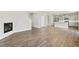 Bright living room with wood floors, white fireplace, and plenty of natural light at 14249 Beebalm Ave, Parker, CO 80134