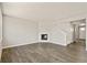 Open living space with wood floors, white walls, and a modern fireplace at 14249 Beebalm Ave, Parker, CO 80134