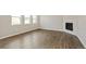 Bright living area featuring wood floors, multiple windows, and a modern fireplace at 14249 Beebalm Ave, Parker, CO 80134
