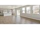 Open floor plan featuring wood floors, a modern kitchen, and natural light from large windows at 14249 Beebalm Ave, Parker, CO 80134
