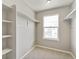 Walk-in closet featuring built-in shelving and natural light from a large window at 14249 Beebalm Ave, Parker, CO 80134
