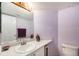 Functional bathroom features a single vanity, a large mirror, and a toilet at 17045 Hastings Ave, Parker, CO 80134