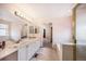 Bright bathroom featuring double sinks, a large mirror, and a separate shower and tub at 17045 Hastings Ave, Parker, CO 80134
