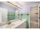 Bathroom with double sinks, large mirror, and access to the shower/tub area at 17045 Hastings Ave, Parker, CO 80134