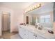Bathroom with double sinks, ample counter space, a large mirror and a shower over tub at 17045 Hastings Ave, Parker, CO 80134