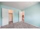 Bedroom featuring plush carpeting, neutral colored walls, closet, and doorway to hall at 17045 Hastings Ave, Parker, CO 80134