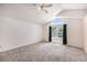 Bright main bedroom with vaulted ceilings, an arched window, and neutral carpeting at 17045 Hastings Ave, Parker, CO 80134