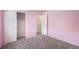 Bedroom featuring closet and door to hallway, neutral colored walls and plush carpeting at 17045 Hastings Ave, Parker, CO 80134