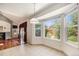 Bright breakfast nook with a bay window offering backyard views, adjacent to the living room at 17045 Hastings Ave, Parker, CO 80134