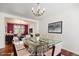 Elegant dining room featuring hardwood floors and a modern glass-top dining table at 17045 Hastings Ave, Parker, CO 80134
