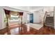 Bright foyer with hardwood floors, staircase, and stained glass accents at 17045 Hastings Ave, Parker, CO 80134