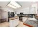 Well-equipped kitchen with white cabinets, stainless steel appliances, a center island, and granite countertops at 17045 Hastings Ave, Parker, CO 80134