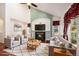 Comfortable living room with a fireplace, vaulted ceilings, and lots of natural light at 17045 Hastings Ave, Parker, CO 80134