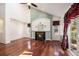 Inviting living room with a fireplace, hardwood floors, and bright windows at 17045 Hastings Ave, Parker, CO 80134