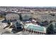 Aerial view of community featuring pool, cabana, parking, and townhomes amid lush landscaping at 16047 E Geddes Ln # 128, Aurora, CO 80016