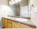 Bright bathroom featuring double sinks and granite countertops at 16047 E Geddes Ln # 128, Aurora, CO 80016